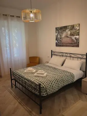 a bedroom with a bed with two towels on it at La casa di Tilde Roma POLDO in Rome