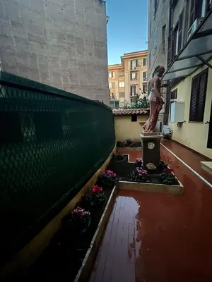 a statue of a woman standing on top of a building at La casa di Tilde Roma POLDO in Rome