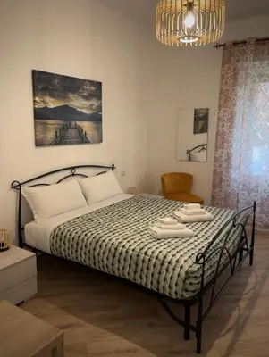 a bedroom with a bed and a chandelier at La casa di Tilde Roma POLDO in Rome