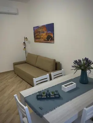 a living room with a table and a couch at La casa di Tilde Roma POLDO in Rome
