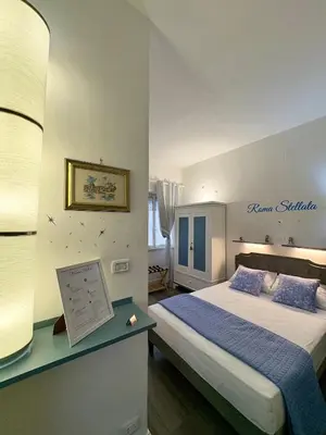 a hotel room with a bed and a desk with aaptop at Roma Stellata in Rome