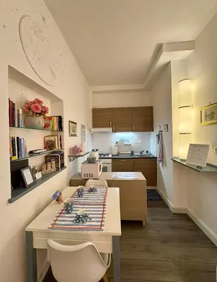 a kitchen with a table and chairs in a room at Roma Stellata in Rome