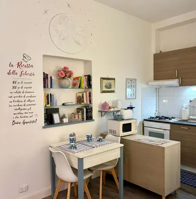 a kitchen with a table and chairs in a kitchen at Roma Stellata in Rome