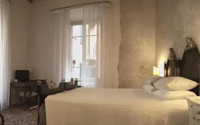 a bedroom with a bed and a window at Vicolo del Lupo Guesthouse in Rome