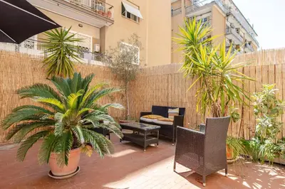 a patio with chairs and plants and a fence at Roma San Pietro - L'Angolo di Marley apt in Rome