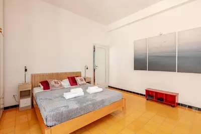 a bedroom with a bed and a painting on the wall at Roma San Pietro - L'Angolo di Marley apt in Rome