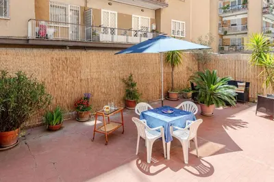 a patio with a table and chairs and an umbrella at Roma San Pietro - L'Angolo di Marley apt in Rome