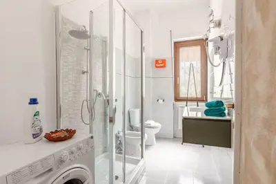 a bathroom with a shower and a washing machine at Roma San Pietro - L'Angolo di Marley apt in Rome