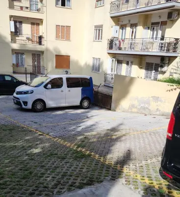 a white car parked in front of a building at Il Pineto in Rome
