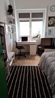 a bedroom with a desk with a computer and a bed at Il Pineto in Rome