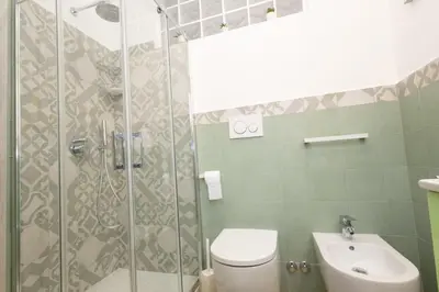 a bathroom with a shower and a toilet and a sink at Casa Libetta in Rome
