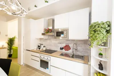 a kitchen with white cabinets and a sink at Casa Libetta in Rome