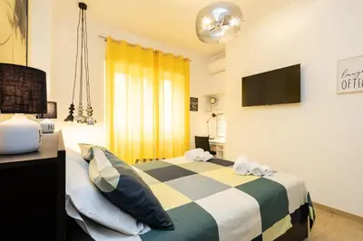 a bedroom with a bed with pillows and a television at Casa Libetta in Rome