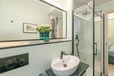 a bathroom with a sink and a mirror at Tu chiamale emozioni 3 suite in Rome