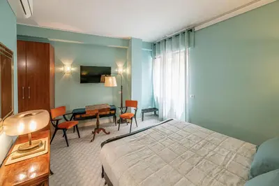 a bedroom with a bed and a table and chairs at Tu chiamale emozioni 3 suite in Rome