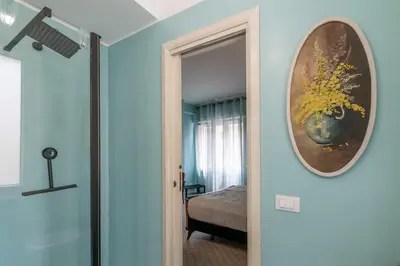 a room with a mirror and a bedroom with a bed at Tu chiamale emozioni 3 suite in Rome