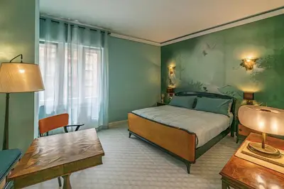 a bedroom with a bed and a desk and a table at Tu chiamale emozioni 3 suite in Rome