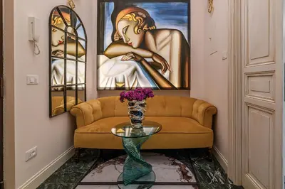 a living room with a couch and a glass table at Tu chiamale emozioni 3 suite in Rome