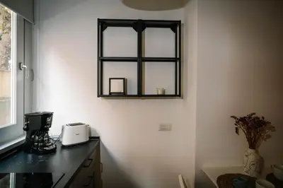 a kitchen with a window on the wall and a counter at Posto del Cuore in Rome