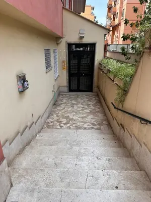 an alley with a black door in a building at Posto del Cuore in Rome