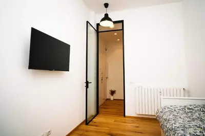 a room with a mirror and a tv on the wall at Posto del Cuore in Rome