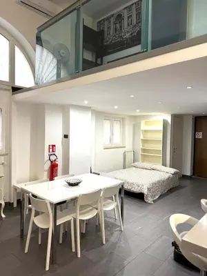 a living room with a table and a bed at Loft in old town near Termini Station and University in Rome