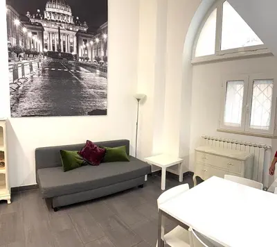 a living room with a couch and a picture of a building at Loft in old town near Termini Station and University in Rome