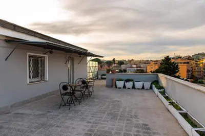 a balcony with chairs and a table on a building at DODO Casa e appartamento per vacanze in Rome