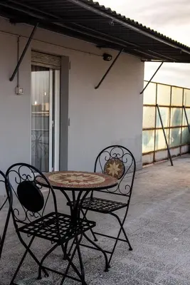 a table and two chairs on a patio at DODO Casa e appartamento per vacanze in Rome