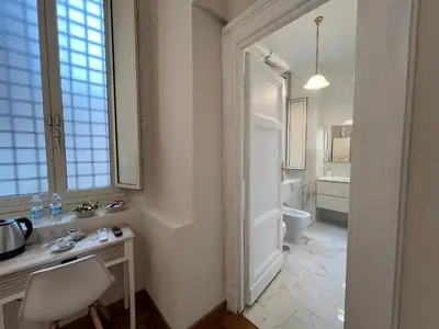 a white bathroom with a desk and a toilet at Marbel's Rooms in Rome