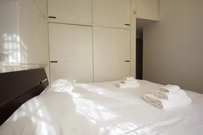 a white bed with towels on top of it at Cipro 2BR Holiday House in Rome