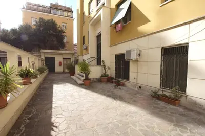 an empty alley with potted plants on the side of a building at Cipro 2BR Holiday House in Rome
