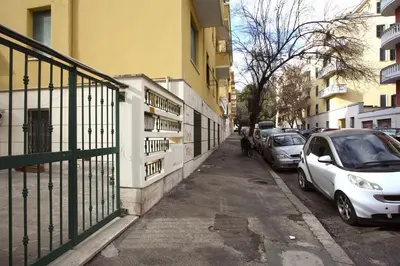a street with cars parked on the side of a building at Cipro 2BR Holiday House in Rome