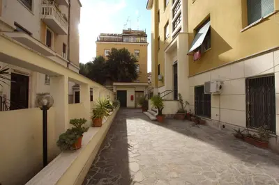 an empty alley with potted plants and buildings at Cipro 2BR Holiday House in Rome