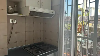 a kitchen with a stove top oven next to a window at The attic in Rome