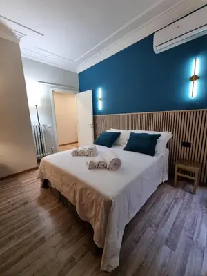 a bedroom with a large bed with towels on it at Papa's House - Re di Roma in Rome