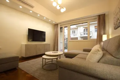 a living room with a couch and a tv at Contessa 3BR Holiday House in Rome