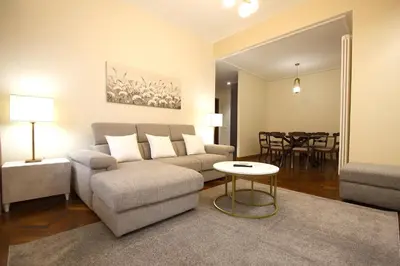 a living room with a couch and a table at Contessa 3BR Holiday House in Rome