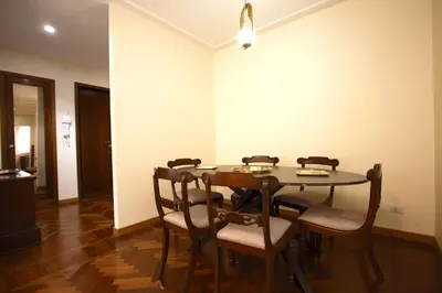 a dining room with a table and chairs at Contessa 3BR Holiday House in Rome