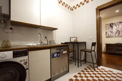 a kitchen with a sink and a dishwasher at Contessa 3BR Holiday House in Rome