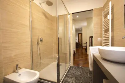 a bathroom with a shower and a sink and a toilet at Contessa 3BR Holiday House in Rome