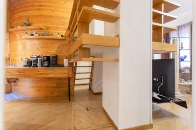 a room with wooden walls and wooden stairs in a house at Oliviero - Colosseo Apartment with Terrace in Rome
