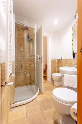 a bathroom with a shower and a toilet and a sink at Oliviero - Colosseo Apartment with Terrace in Rome