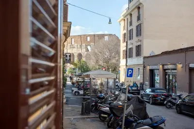 a group of motorcycles parked on a city street at Oliviero - Colosseo Apartment with Terrace in Rome