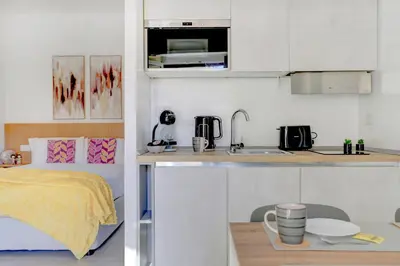 a small kitchen with a sink and a bed at Vatican Loft with Balcony - Home and More in Rome