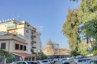 a parking lot with cars parked in front of a building at Vatican Loft with Balcony - Home and More in Rome
