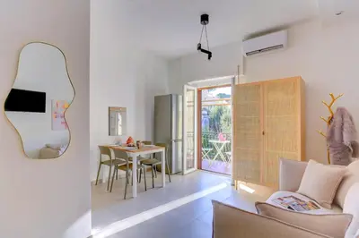 a living room with a table and a mirror at Vatican Loft with Balcony - Home and More in Rome