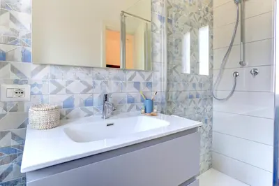 a bathroom with a white sink and a shower at Vatican Loft with Balcony - Home and More in Rome