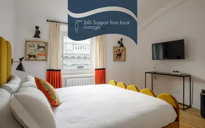 a bedroom with a white bed and a tv at Daplace - Costanza Apartment in Rome