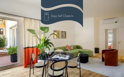 a living room with a table and a green couch at Daplace - Costanza Apartment in Rome